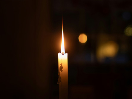 A single candle in a dark room