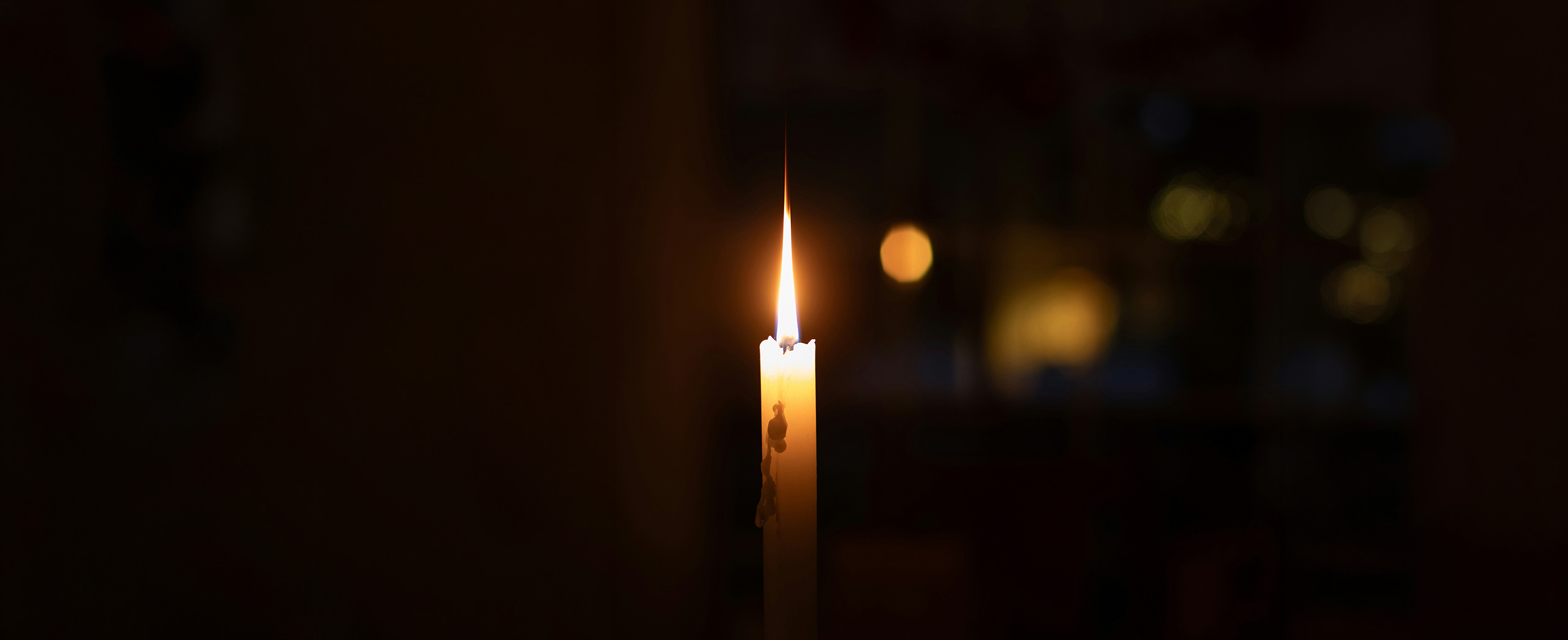 A single candle in a dark room